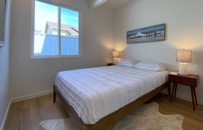 Boho Chic beach house home staging at Faria Beach, guest bedroom one with a walnut platform bed
