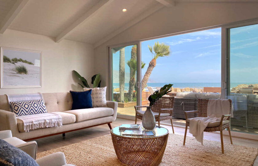 Boho Chic beach house living room facing couch and ocean behind