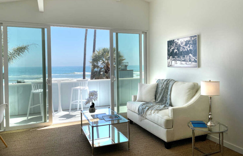 Boho Chic beach house home staging at Faria Beach, seating area and balcony in master bedroom