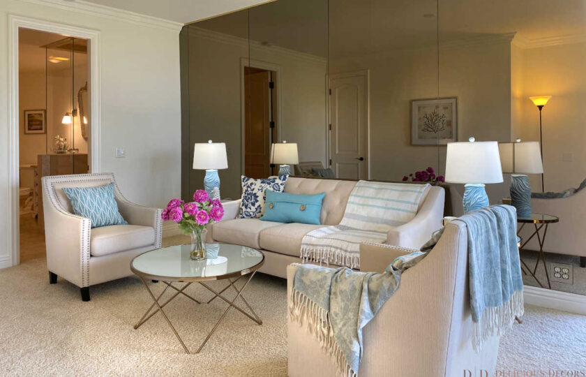 Transitional home staging design of family room, facing mirrored back wall, in Montecito Shores two bedroom condo