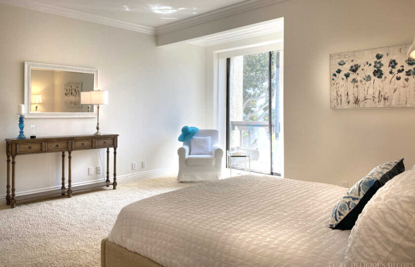 Transitional home staging design of master bedroom, facing corner window, in Montecito Shores two bedroom condo