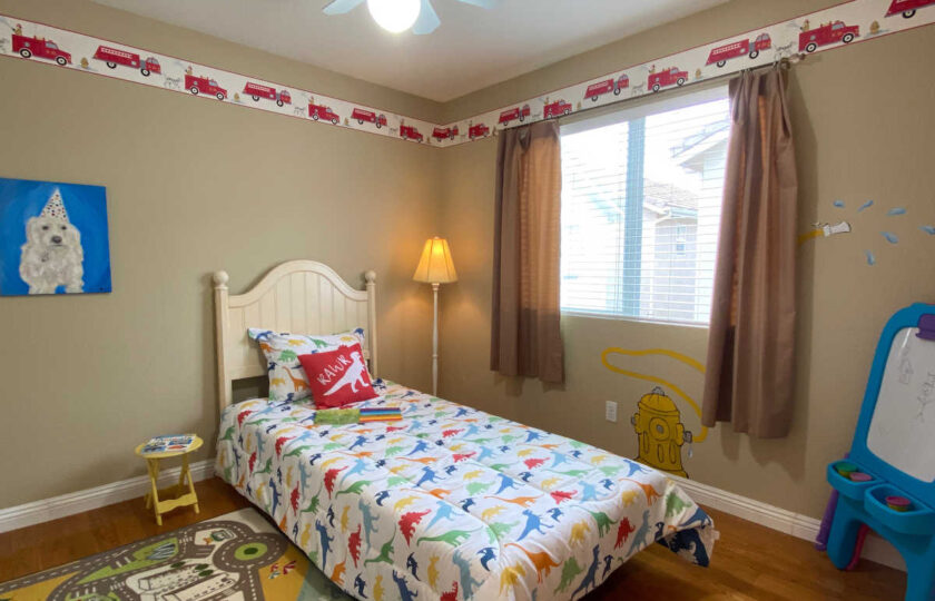 Townhouse kid's bedroom with dinosaur themed, including painted walls and bedding