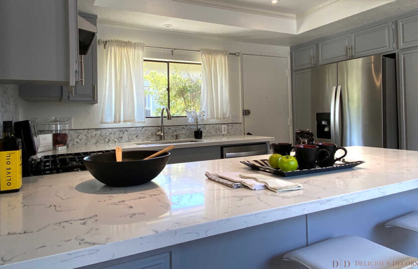 White marble kitchen counter top and light gray cabinets