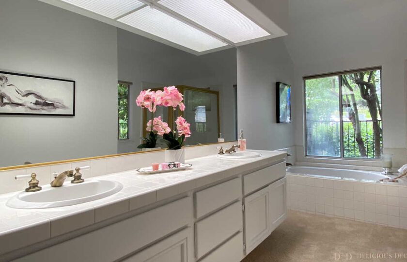 Master bathroom with two sinks and tub with a window view