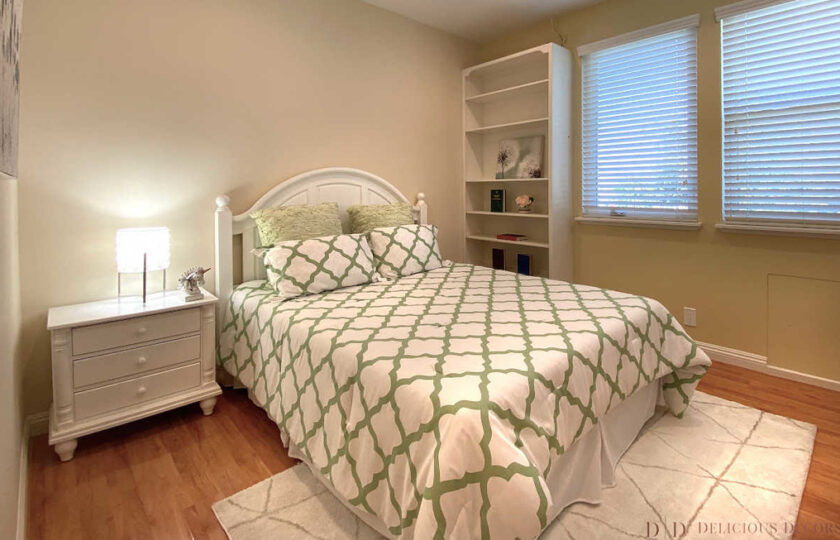 Guest bedroom with white bed and green and white bedding