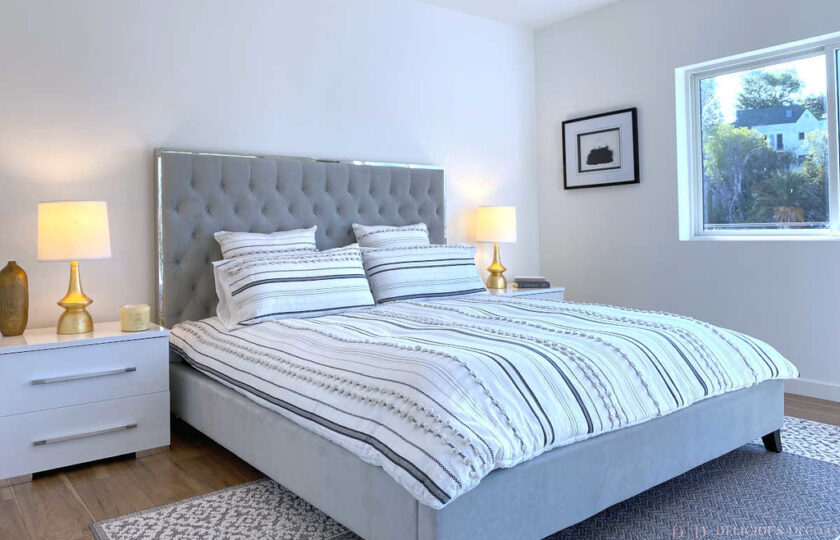 Master bedroom with gray king size bed with white and gray bedding