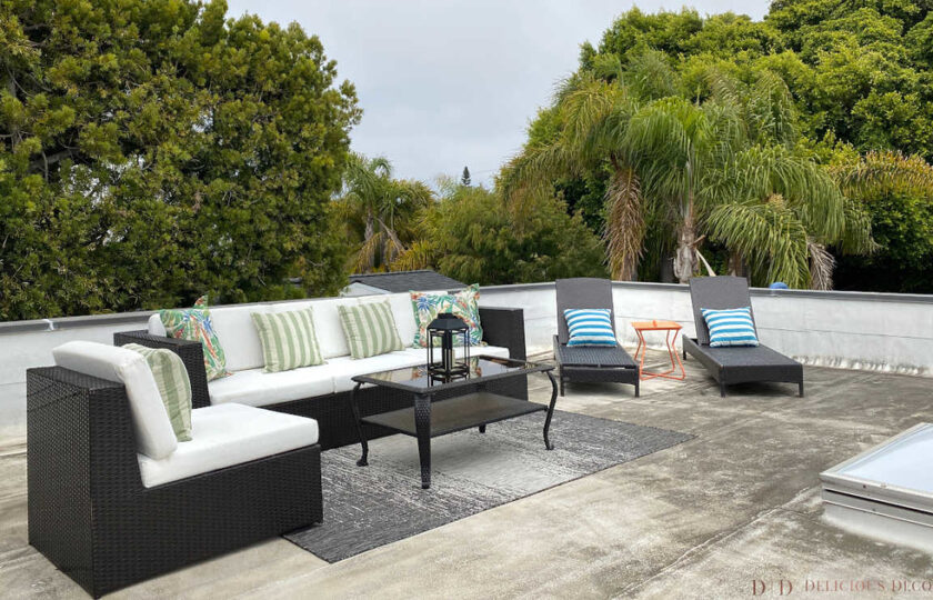 outdoor deck with sofa and chairs and coffee table