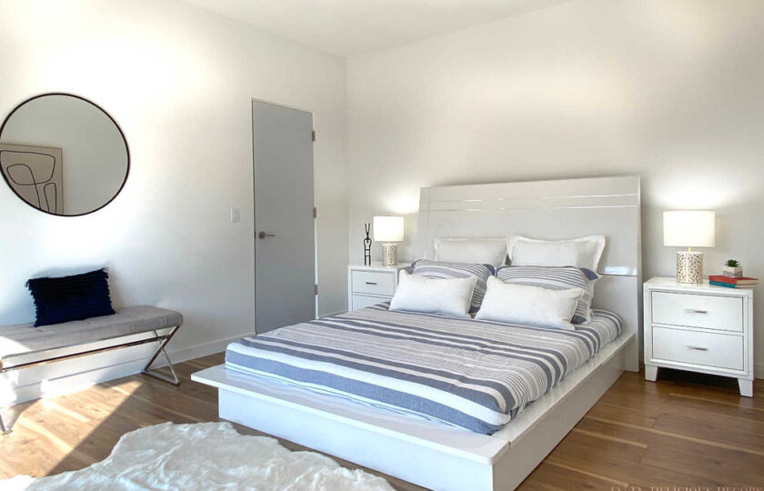 Guest bedroom with white bed and white and gray bedding