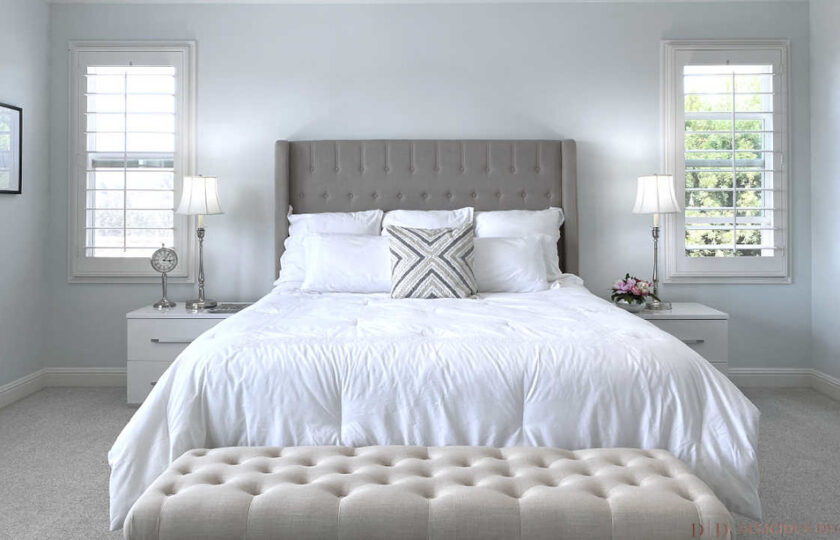 master bedroom with king size gray bed and white bedding