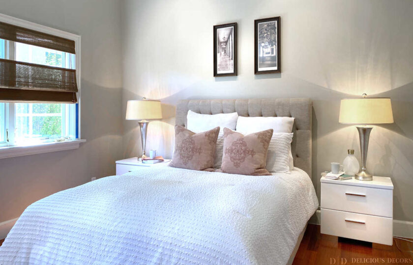 guest bedroom with a bed with white linens and throw pillows