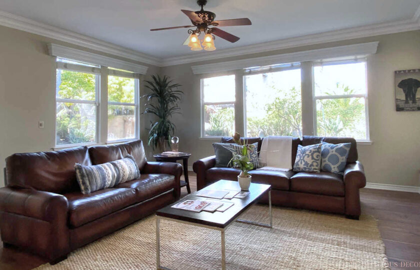 family room with brown leather sofas and coffee table in the center