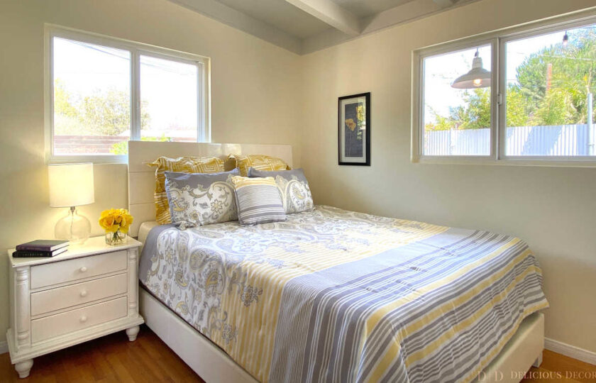 Bohemian style guest bedroom with yellow and gray bedding