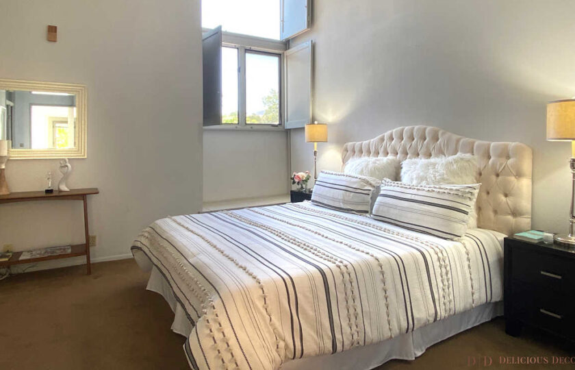 Master bedroom with white and gray bedding