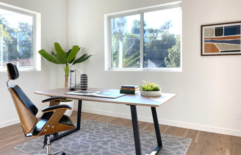 Home office with mid-century furniture and window view