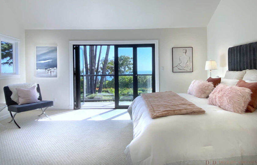 contemporary master bedroom with bed and chair on the side