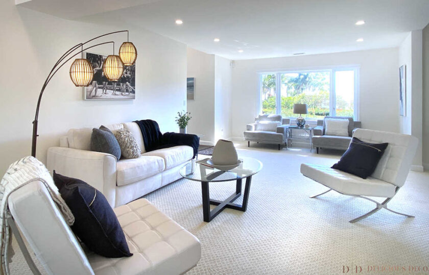 contemporary living room with white couch and two chairs and coffee table