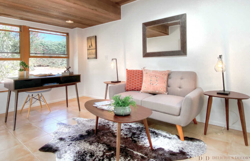 Mid-century modern bonus room with love seat, desk, and cowhide rug