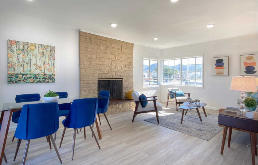 Greatroom with mid-century modern home staging design and blue accent color facing the fireplace