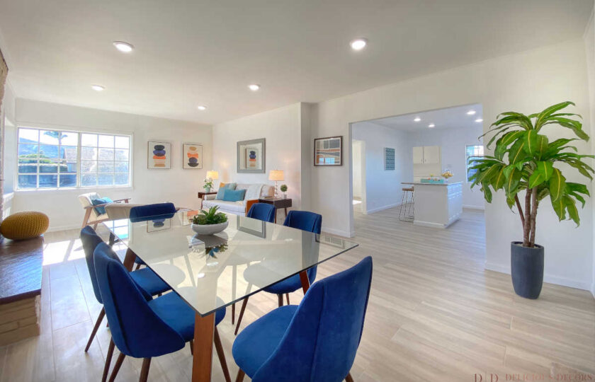 Greatroom with mid-century modern home staging design and blue accent color facing the kitchen