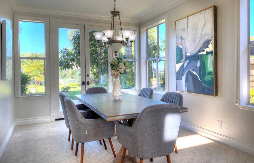 Dining room with a reclaimed wood rectangular table and upholstered mid-mod chairs