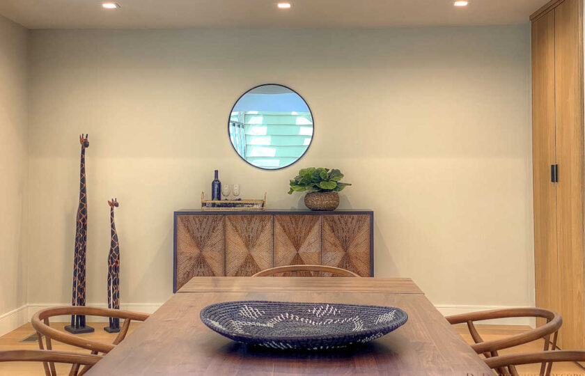 Dining space with mid-mod buffett and circular mirror above