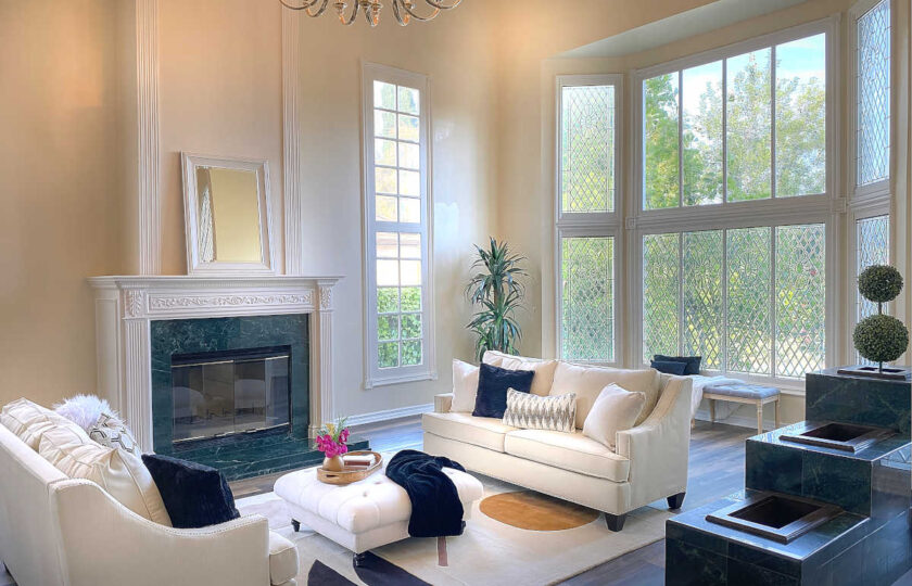 Living room home staging with white mirror over fireplace