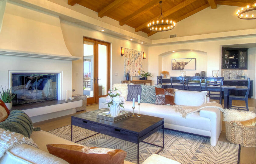 Living room with wood beam cathedral ceiling and floor to ceiling fireplace