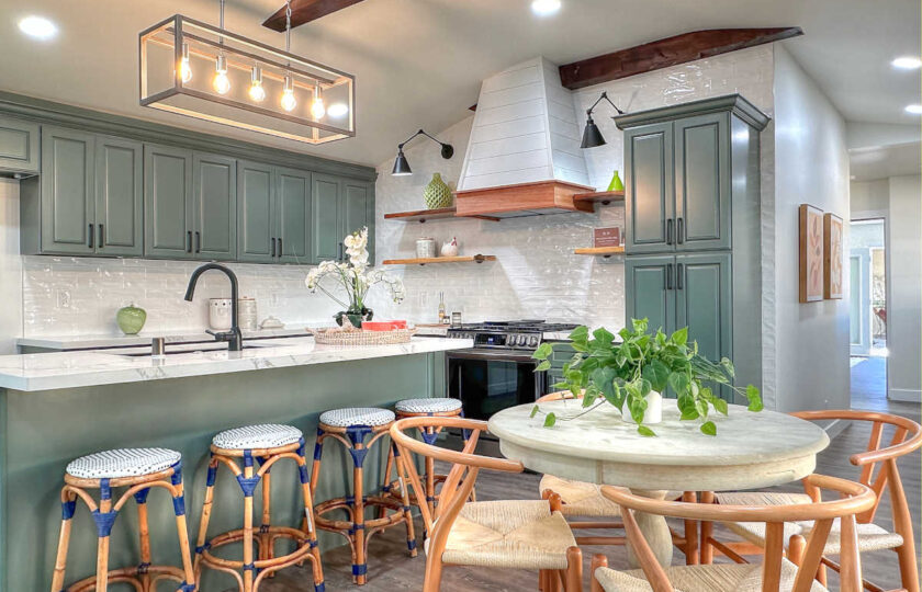 The kitchen of this Ojai, CA property that shows off wishbone oak dining chairs & kipnuck barstools.