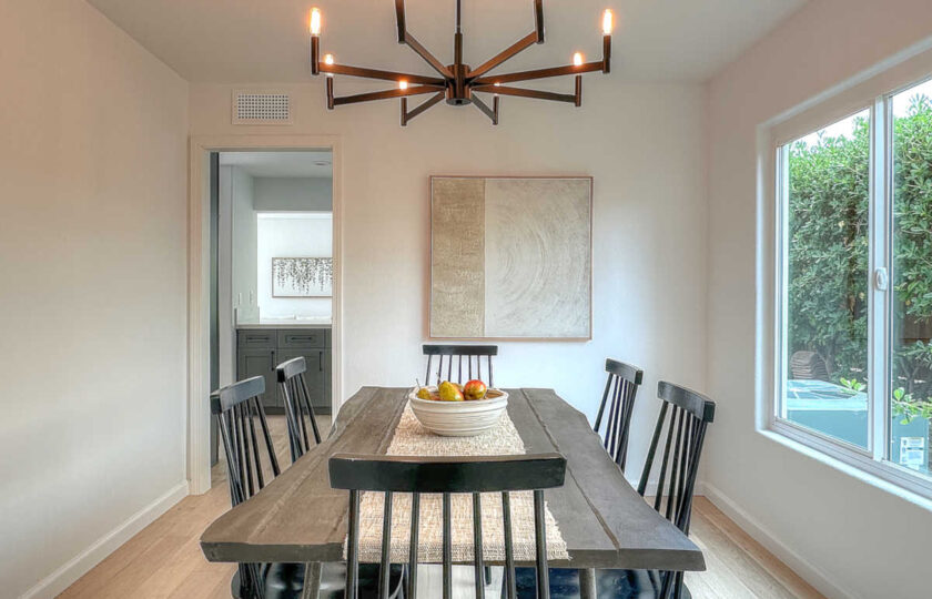 The dining room staging with live edge dining table and black, modern farmhous spindle side chairs.