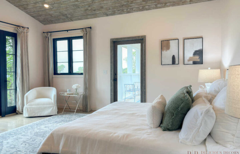 Modern artwork juxtaposes with traditional pieces like a slip-cover barrel chair in the corner to blend old and new, Modern and Farmhouse.