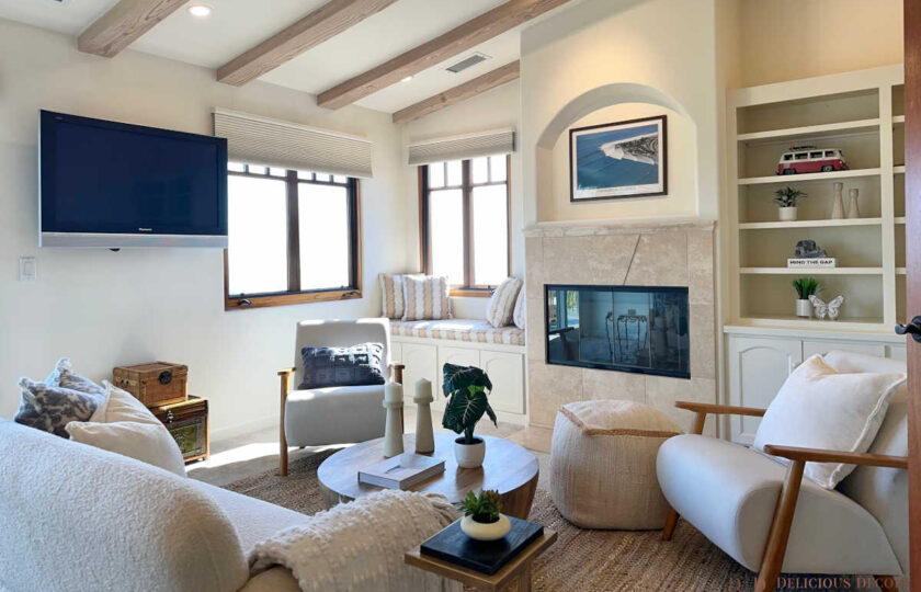 The upstairs den has a loungier vibe, staged with a boucle love seat and two Andablo upholstered armchairs.