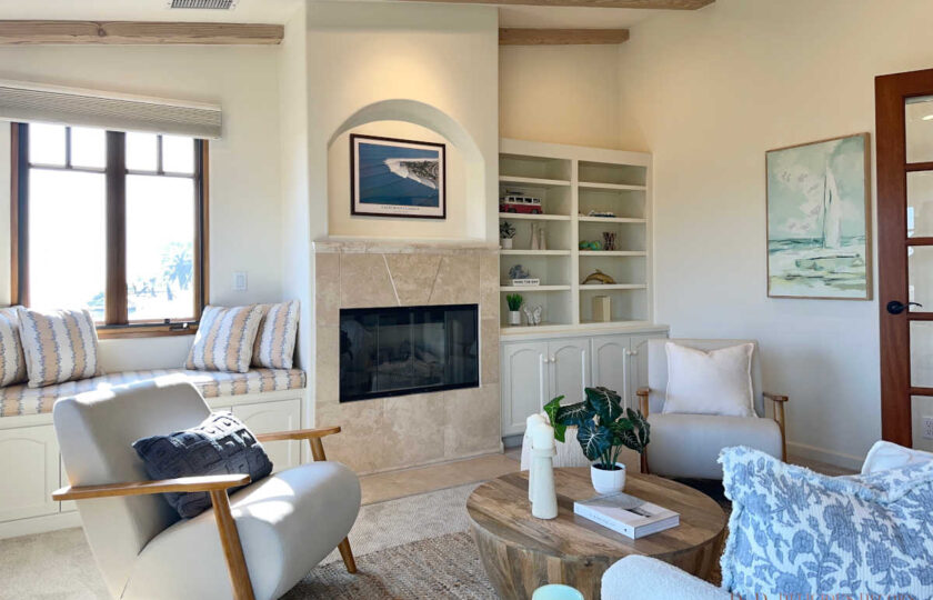 The den features beach art, including a poster of Rincon, the famous surf spot.
