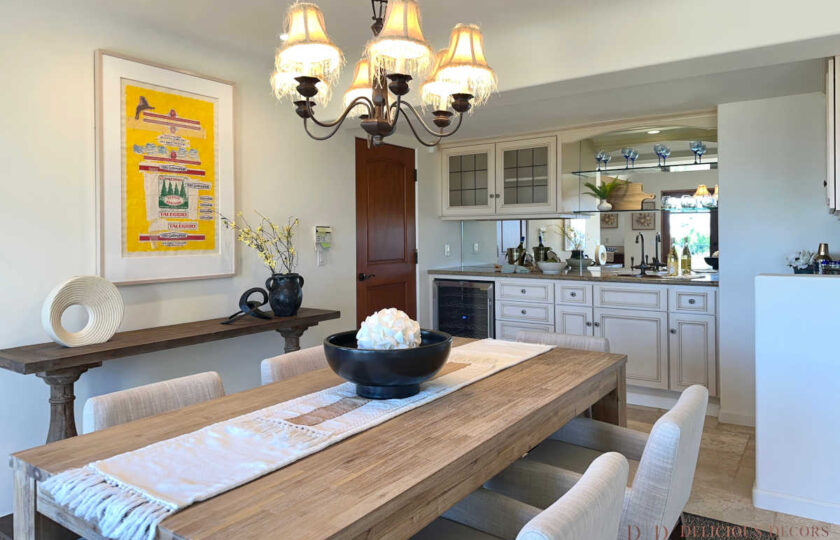 Santa Barbara home staging always has room for some seashells, in this case subtly placed inside the black wood bowl centerpiece atop the brushed smoke dining table and layered runner.