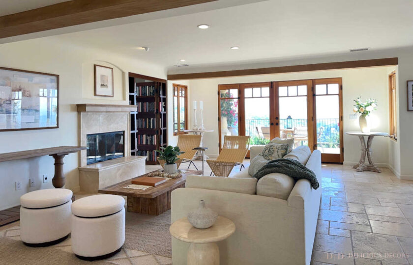 The tavertine flooring, mahogany french doors, and exposed wood-beam ceilings set the foundation for a Mediterranean Revival home staging design in Santa Barbara, CA.