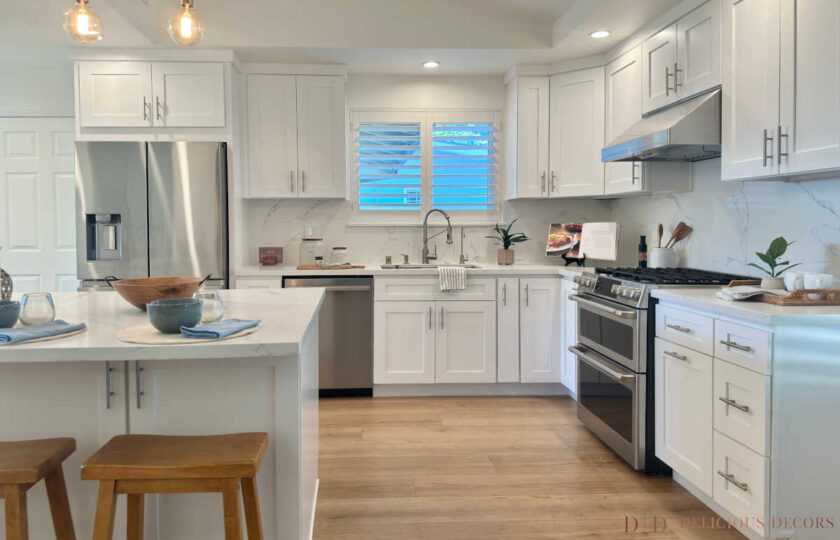 Bright, modern kitchen featuring white shaker cabinets, a marble-veined quartz island, and natural wooden barstools for a family-friendly design.