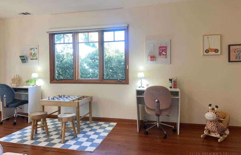 Playful children's room in our Santa Ynez luxury estate staging, featuring a pine chess table, small workstations, and a blue checkered rug.