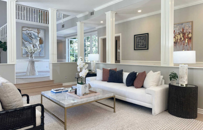 Westlake Village vacant staging highlighting open-concept formal living space with view toward grand foyer and double staircase.