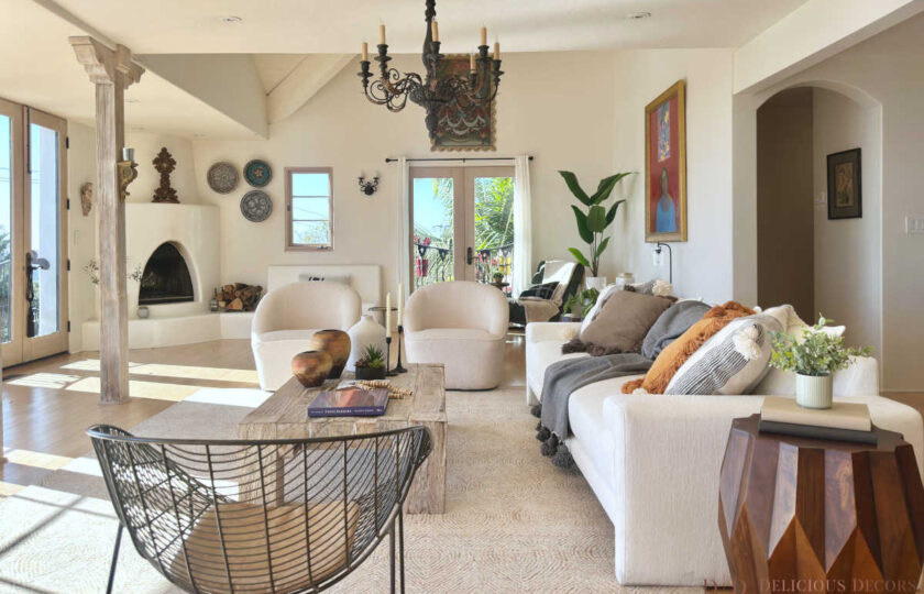 Bright living room showcasing expert Spanish Colonial staging, a kiva fireplace, neutral sofa, and natural wood accents in Santa Barbara.