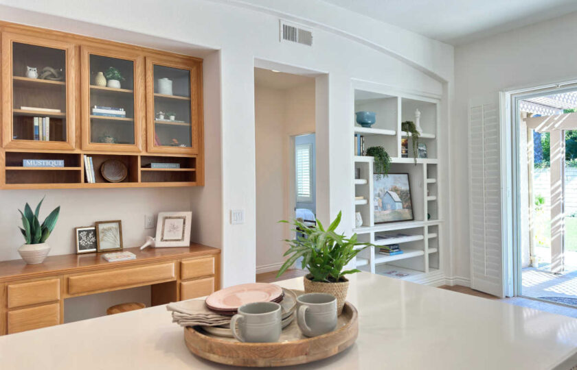 Custom oak built-in desk and white display shelves styled with modern decor accents in a Thousand Oaks home.