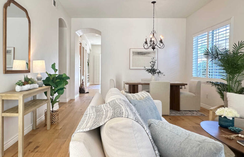 Bright entry console table and foyer view leading into a staged living room and formal dining space in Thousand Oaks.