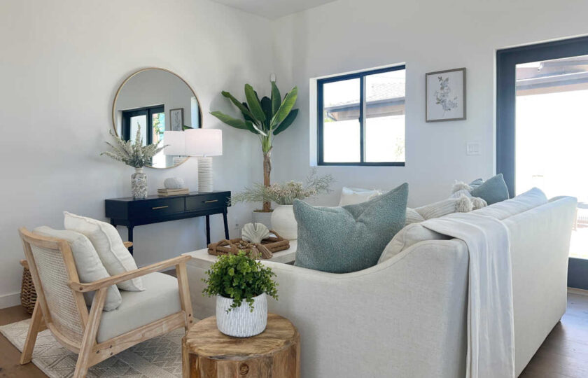 Staging Redondo Beach Modern Coastal with white sectional, natural oak accents, navy console, and gold mirror.