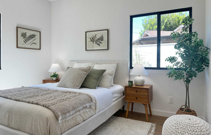 Staging Redondo Beach Modern Coastal with neutral bedding, mid-century wood nightstands, and botanical fern art.