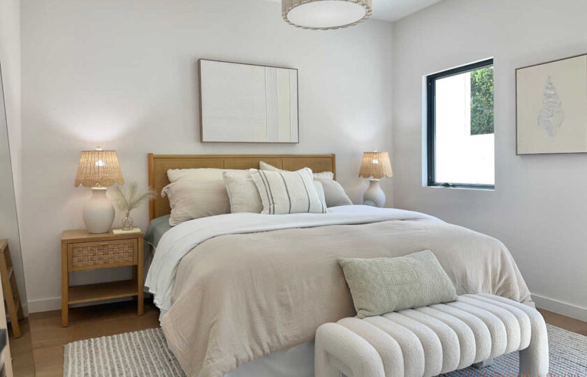 Staging Redondo Beach Modern Coastal featuring rattan headboard, woven lamps, and striped coastal throw pillows.