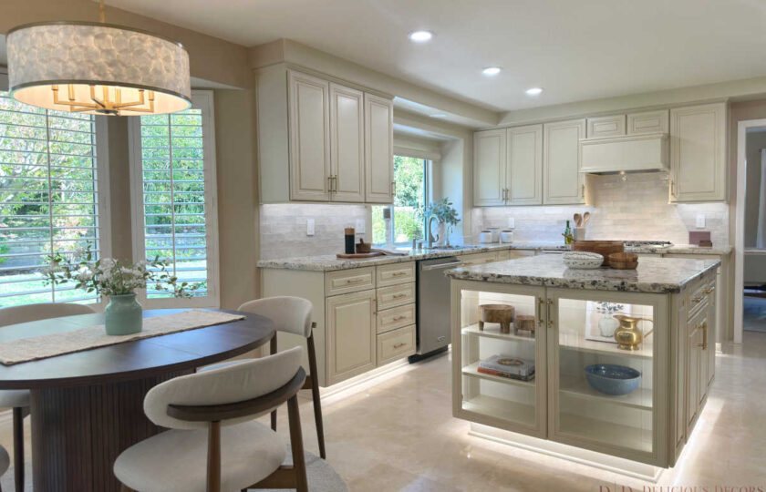 Westlake Village home staging in a modern kitchen featuring illuminated glass island cabinets, granite countertops, and a round breakfast nook table.