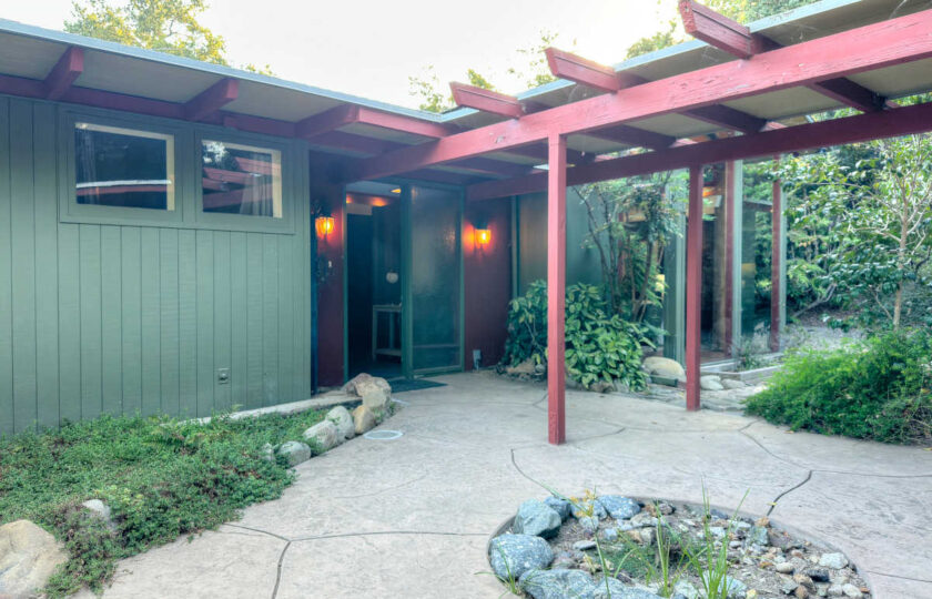 Ojai MCM Ranch exterior front entryway featuring 1957 post and beam architectural details and staged outdoor pathway.